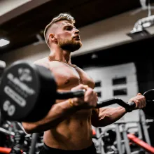 Man doing biceps curls with a barbell