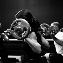 3 people doing lunges with barbells