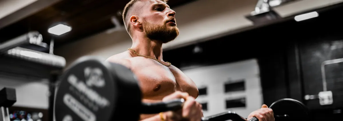 Man doing biceps curls with a barbell