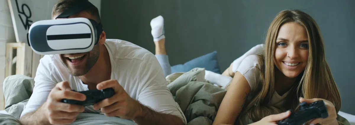 man and woman playing games on console using vr